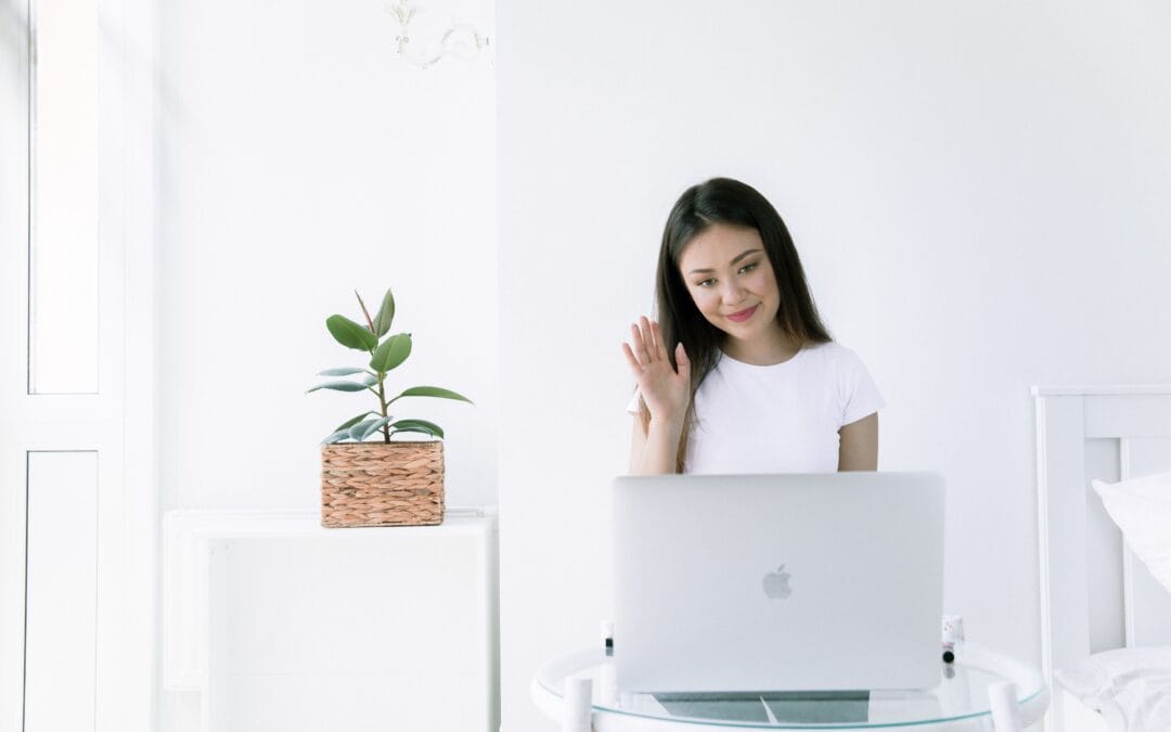 Witness raising her hand to be sworn in at a virtual deposition